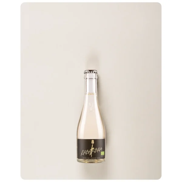 Rabarbra Brut Organic MINI bottle photographed against a grey background