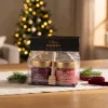 Two-honey gift set with dipper 2 × 100 g – honey with blueberries and honey with cranberries in a warm Christmas gifting setting.