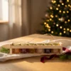 Six-honey gift set in a wooden crate 6 × 50 g – blossom honey and five flavoured honeys in a warm Christmas gifting setting.