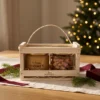 Blossom honey 300 g and honey-salt nuts 110 g in a wooden gift box in a warm Christmas gifting setting.