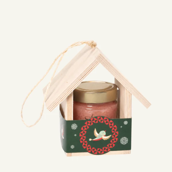 Wooden bird feeder with 300 g honey with cranberries, green sleeve, on a warm light background.